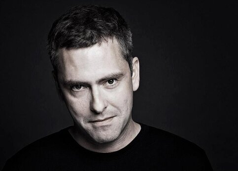 Black and white portrait of a man against a dark background